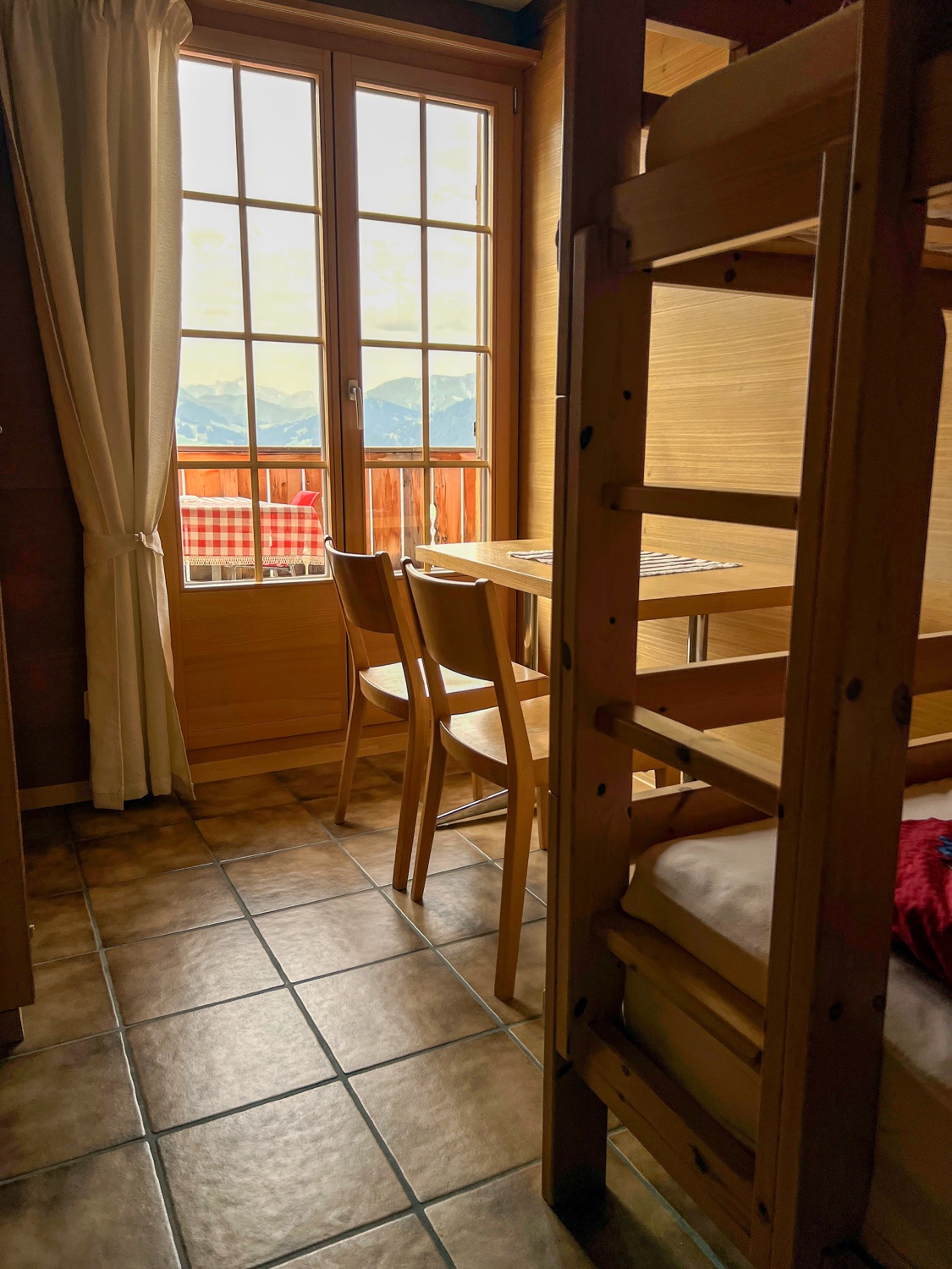Bunk beds and a table at the window